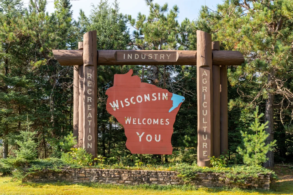 Cannabis leaves beside a Wisconsin map highlighting state marijuana regulations.